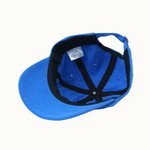 A bright blue baseball cap shown from an overhead angle, revealing a black adjustable interior with black straps and a white size label.