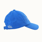 A bright blue baseball cap with a curved brim, featuring white embroidered text reading 'MINI PIKO' on the side and a small white embroidered logo on the front, set against a plain off-white background.